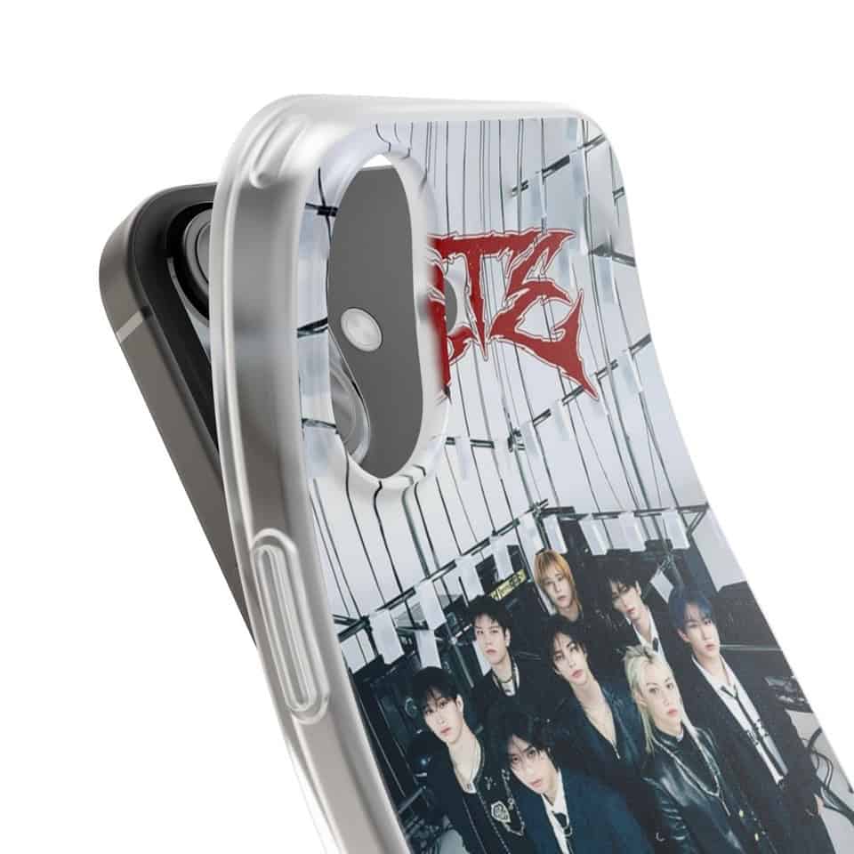 Photo of a iPhone with K-pop merchandise featuring members of a K-pop group and the group's logo in red.