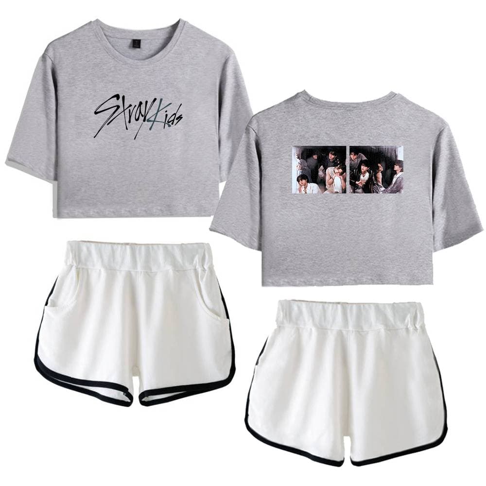 Kpop merch Featuring Gray Kids cropped sweatshirt with black lettering and group photo print on the back, paired with white athletic shorts with black trim.