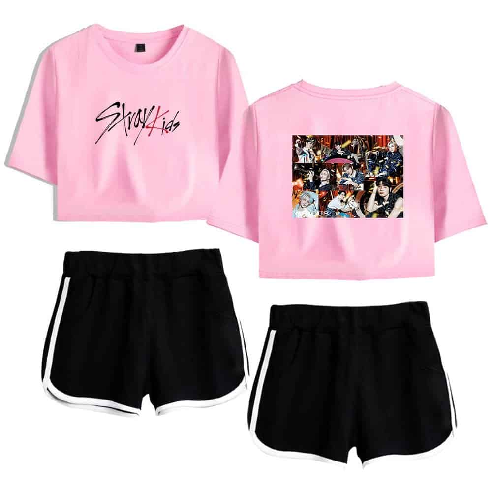 Pink crop top with Stray Kids logo and photo collage, black sporty shorts with white trim, K-pop merchandise, stylish fan apparel, BTS concert outfit.