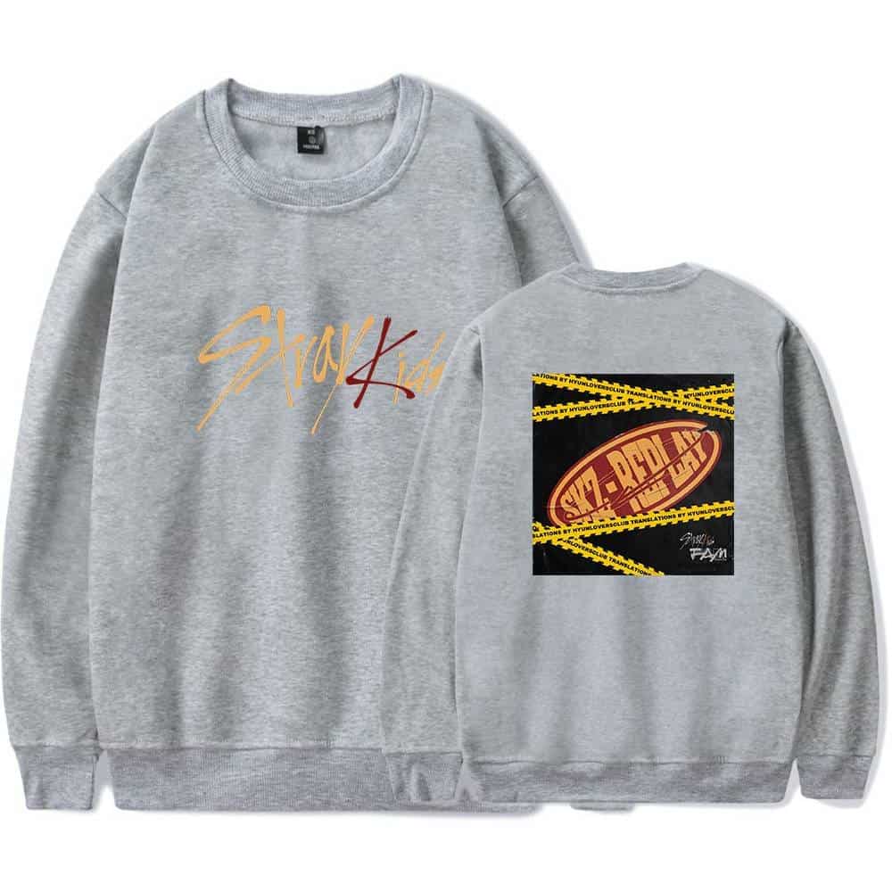 Comfortable grey sweatshirt with "Stussy Kid" graphic and back print featuring bold yellow warning tape and red logo. Perfect for K-pop merch fans.