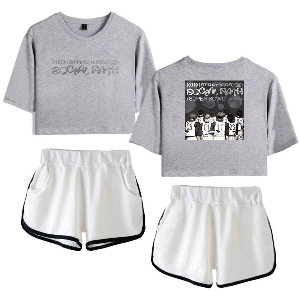 Kpop merch set featuring gray crop tops with social cause graphics and white athletic shorts with black trim.